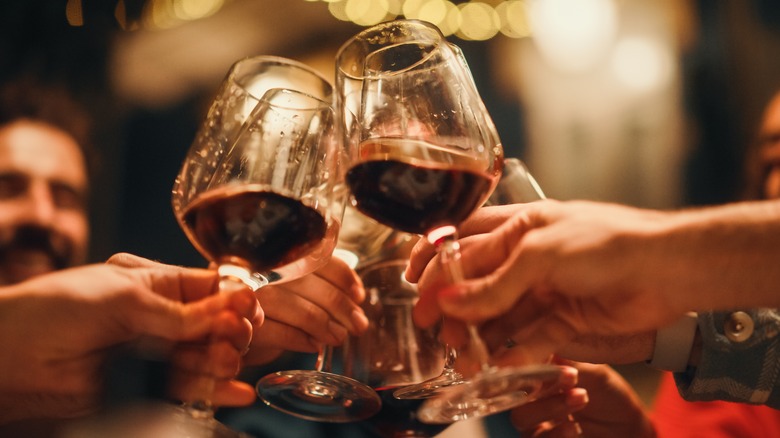 people toasting with glasses of wine