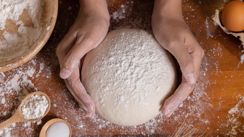 Hands with dough and flour 