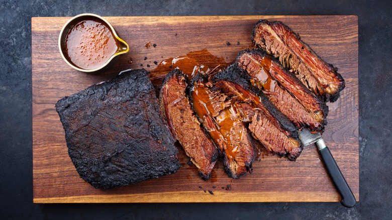 Sliced smoked brisket and sauce