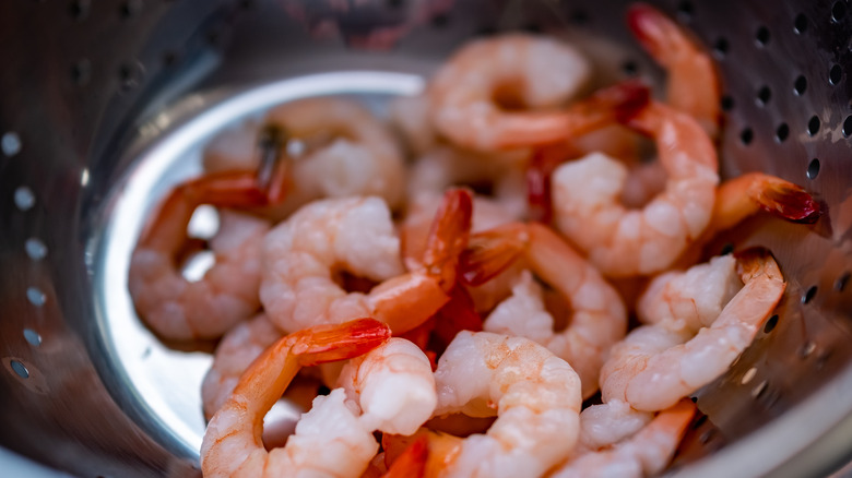 Shrimp thawing in colander