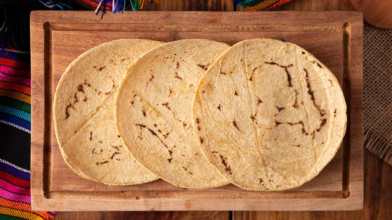 Homemade corn tortillas on cutting board