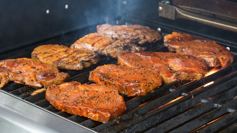 Marinated meat cooking on grill