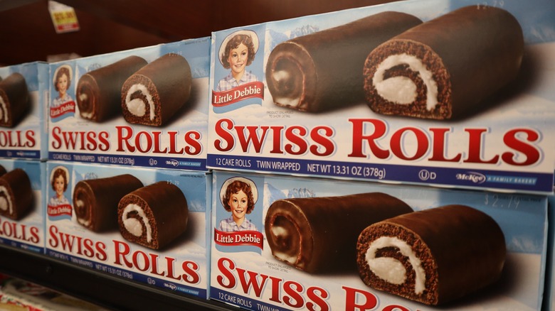 Boxes of Little Debbie Swiss Rolls sit on a shelf at a grocery store