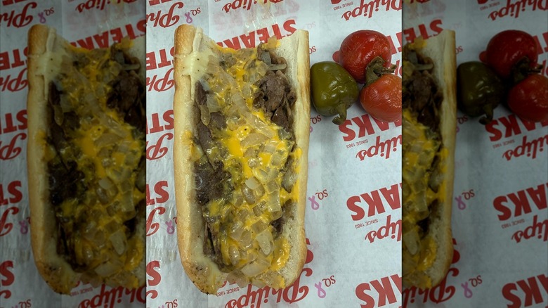 A Philly cheesesteak from Philip's on branded wrapping with three peppers