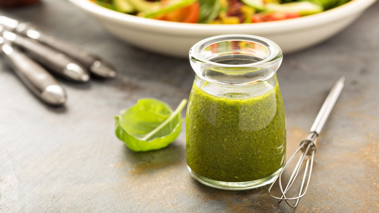 green dressing and whisk