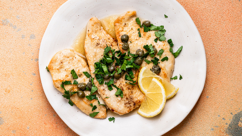 A plate of chicken piccata