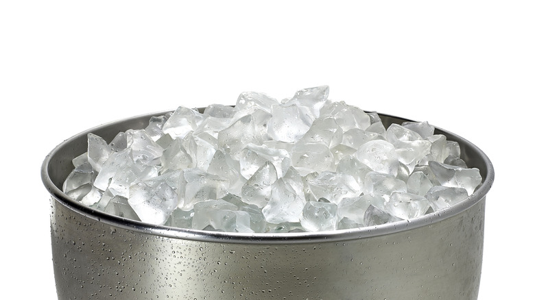 Crushed ice rests in a metal bucket.