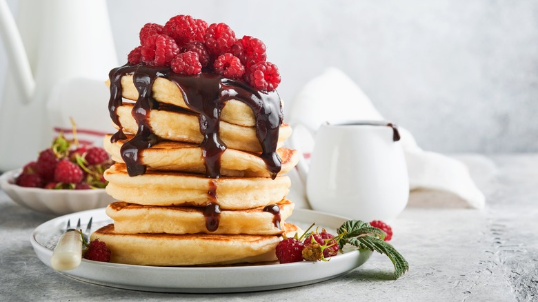 Pancakes with chocolate and raspberry toppings