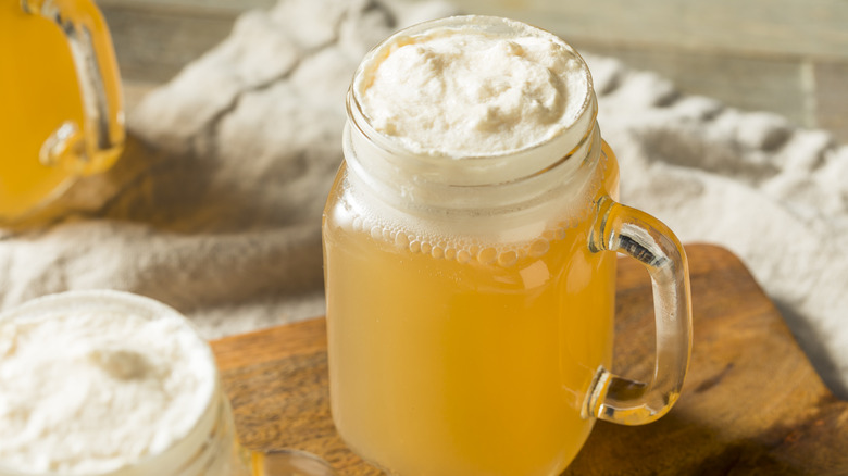 A mug of butterbeer and whipped cream