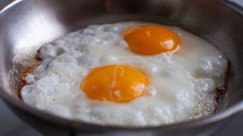 frying eggs in skillet