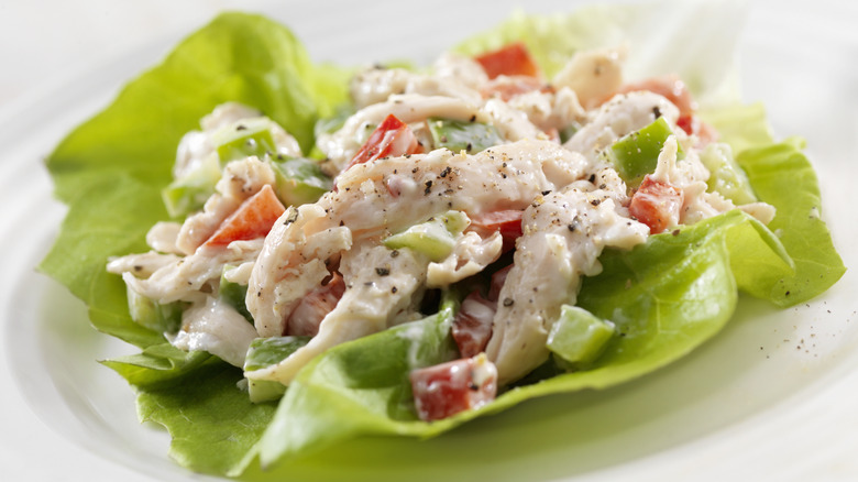 Chicken salad with tomato and pepper on lettuce