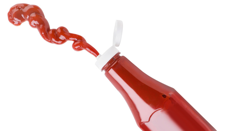 Ketchup bottle squeezing ketchup