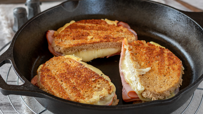 Making grilled cheese sandwiches in hot skillet