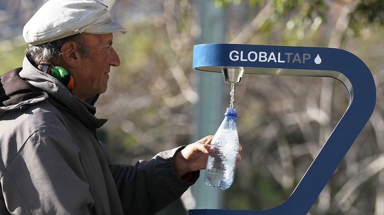 Man refilling plastic water bottle