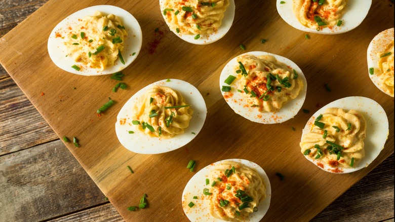 deviled eggs on cutting board