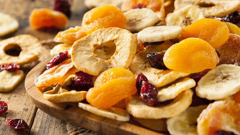 Assorted dried fruit on a wooden plate