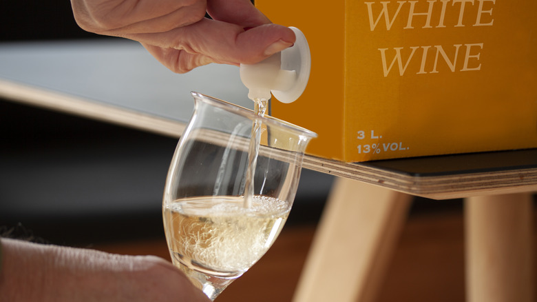 Pouring white wine from box