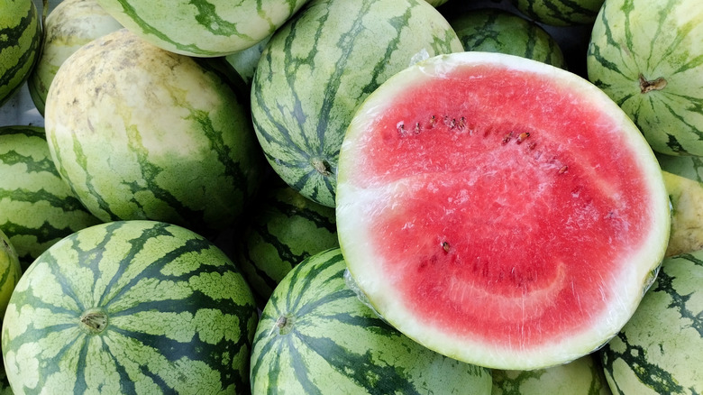 halved watermelon on a pile of watermelons