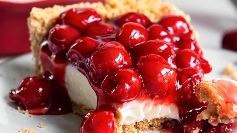 Slice of cherry pie with cream cheese layer