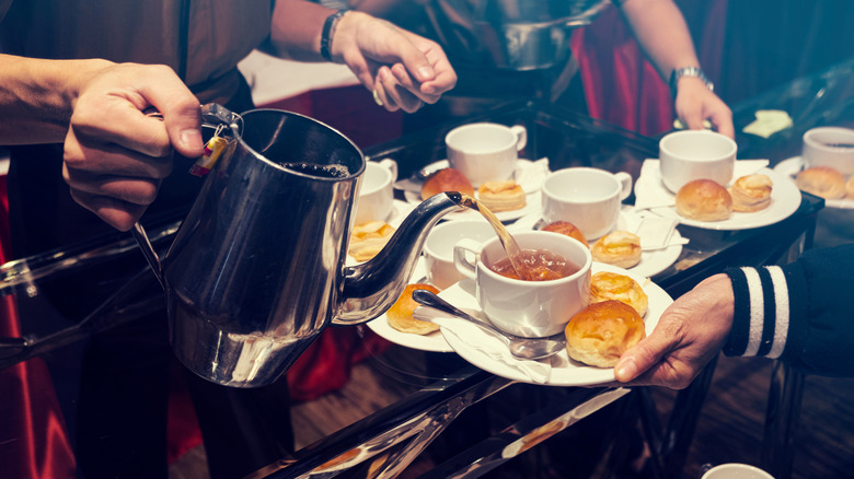 server pouring tea