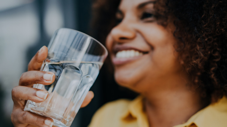 woman holding glass of water