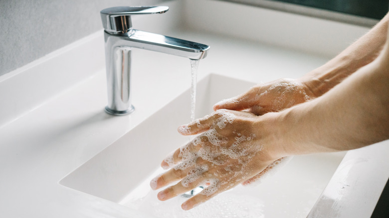 soapy hands and bathroom sink