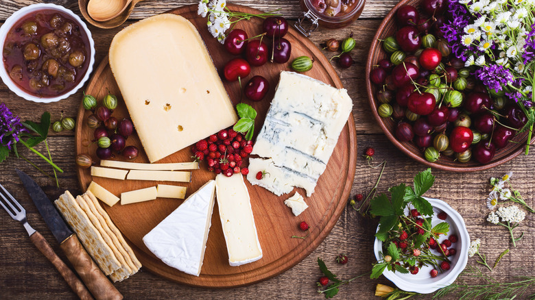 Cheeses, fruits, and olives in bowls and platters