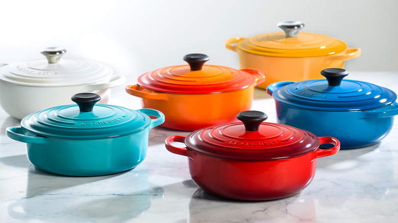 Colorful line of different Le Creuset Dutch ovens