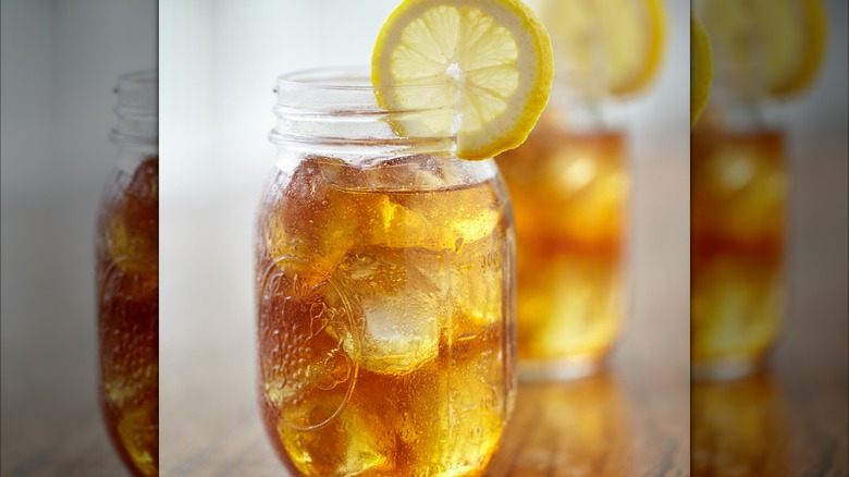 Two glasses full of sweet tea wait patiently on a table.