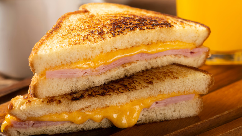 diagonally cut halves of grilled ham and cheese stacked 