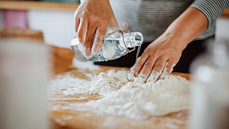 Pouring water on flour