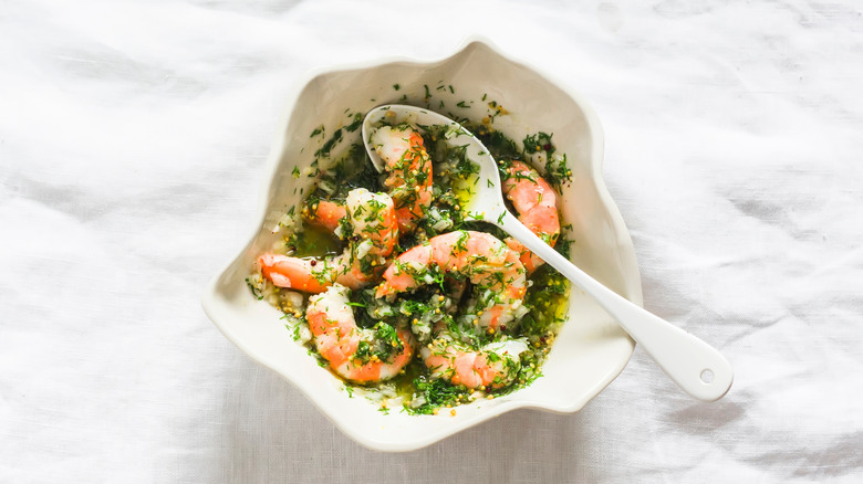 A bowl of marinated shrimp.