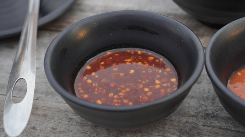 A bowl of fish sauce and cayenne pepper, a great base for a fish marinade.