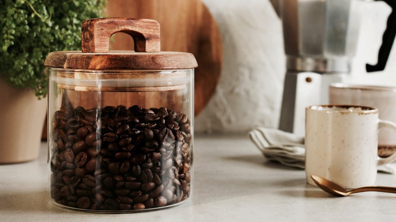 A glass of jar of coffee beans