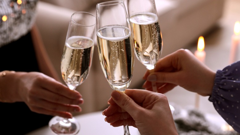 People raise champagne flutes in a toast