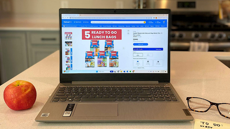 Open laptop on kitchen table showing a lunch bag order from Yumble