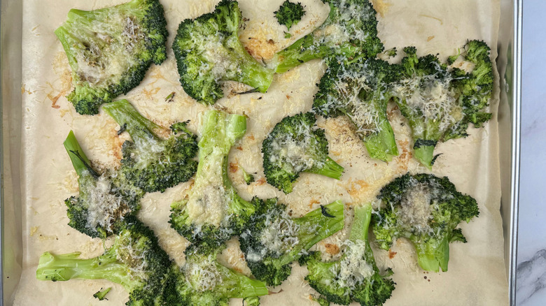 za'atar and parmesan smashed broccoli on baking sheet