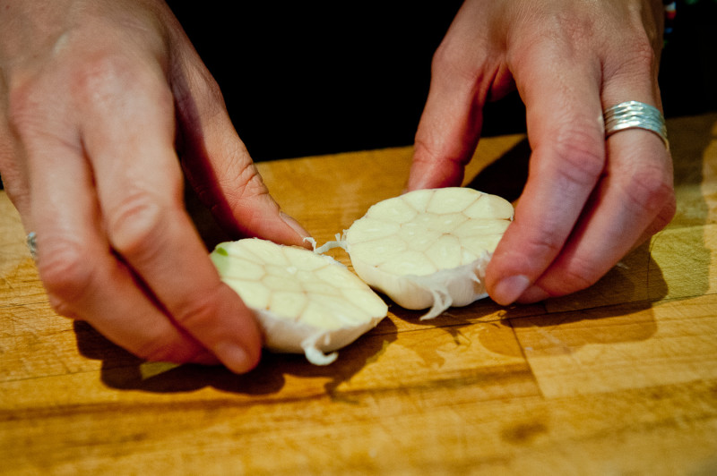 Slice the garlic head in half - Food Republic